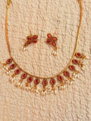 Stylish ruby necklace with oval pearl hangings
