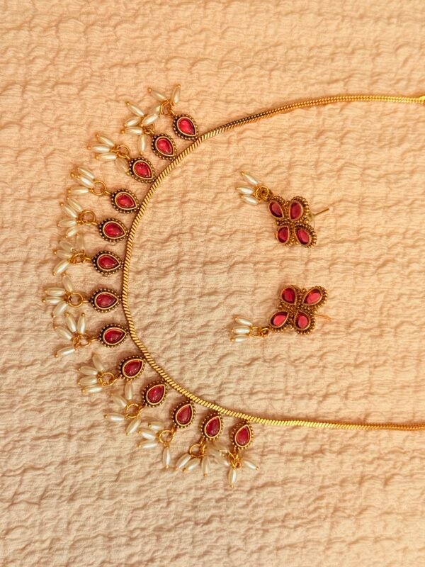 Stylish ruby necklace with oval pearl hangings